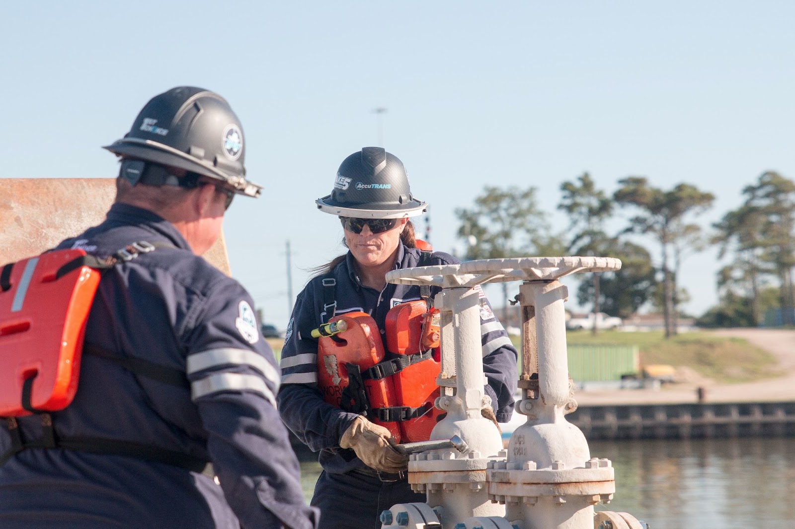 A shoreside tankerman PIC working with her colleague after finding the perfect location when browsing tankerman jobs online.