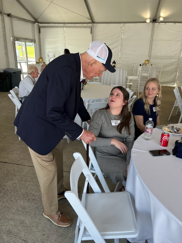 Dave having a conversation with AccuTRANS Director of Accounting Shelby Ryals; he was well-known for always making time to talk to employees.