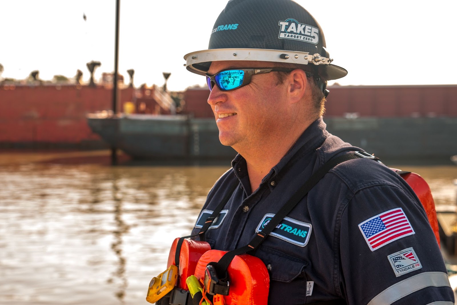 AccuTRANS employee wearing barge PPE helmet with the Take 5 logo on it as a reminder of shore tankerman job safety.